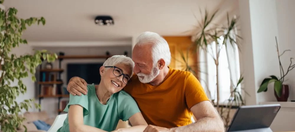 Sweet mature couple, lovingly embracing each other, after a hard day.