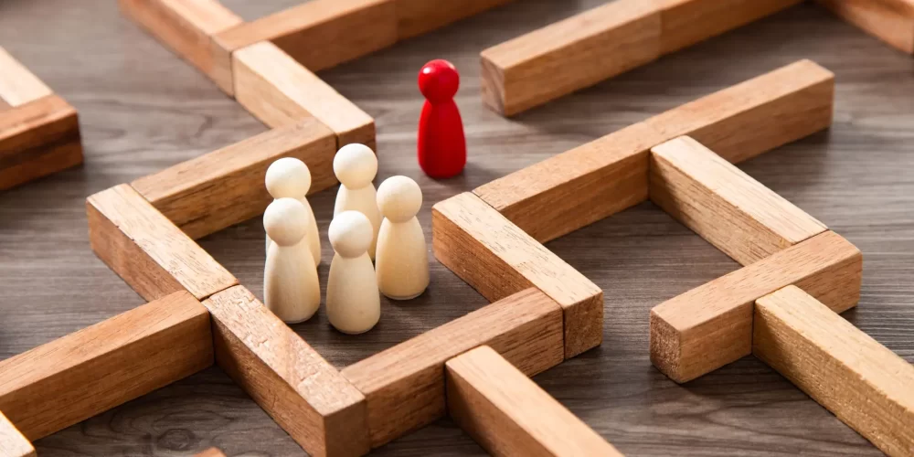 Leadership concept.Wooden miniature at the start point of puzzle maze wood block